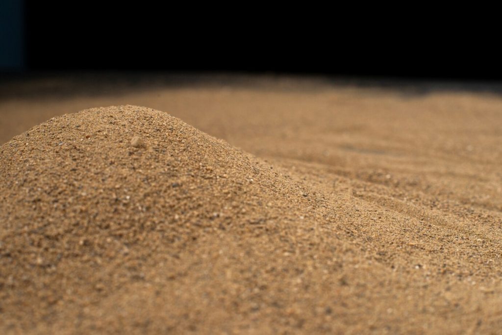 brown-sand-surface-black-wall_179666-37340